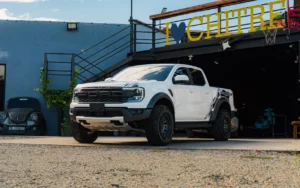 Camioneta pick-up Ford Raptor blanca estacionada frente a un local con letrero de Chitré.